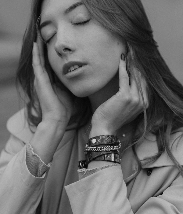 Woman looking into the distance with a calm and peaceful expression.